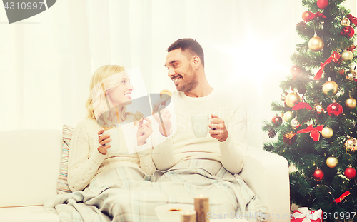 Image of happy couple at home with christmas tree