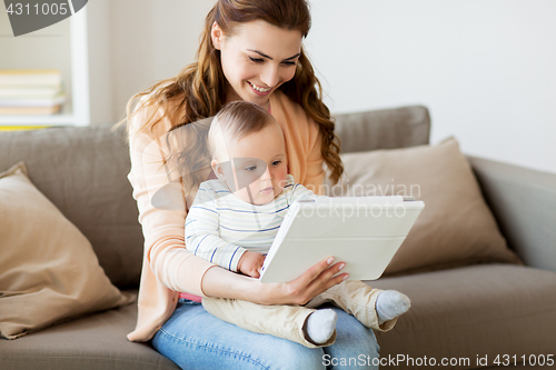 Image of happy mother with baby and tablet pc at home