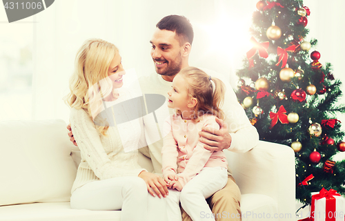 Image of happy family at home with christmas tree