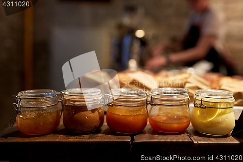 Image of jars with craft jam or sauce at grocery store