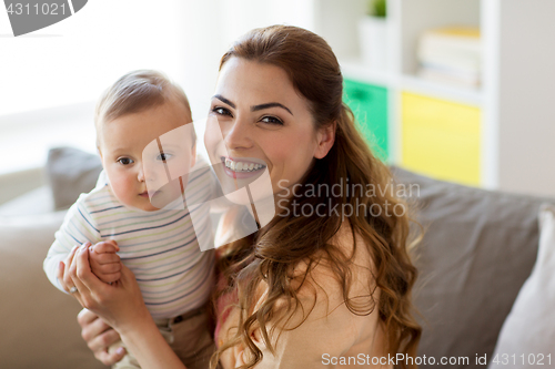 Image of happy young mother with little baby at home