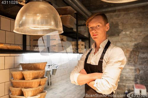 Image of chef or baker in apron at bakery kitchen