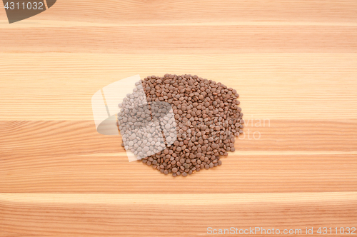 Image of Brown lentils on wood