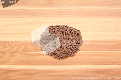 Image of Brown lentils on wood