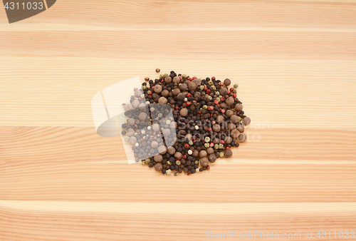 Image of Mixed peppercorns on wood