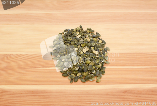 Image of Pumpkin seeds on wood