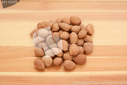 Image of Almonds in shells on wood