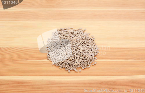 Image of Hulled sunflower seed hearts on wood