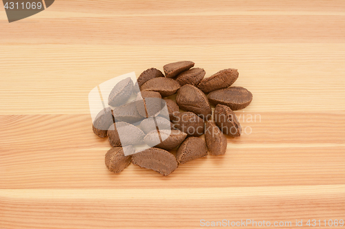 Image of Brazil nuts in shells on wood