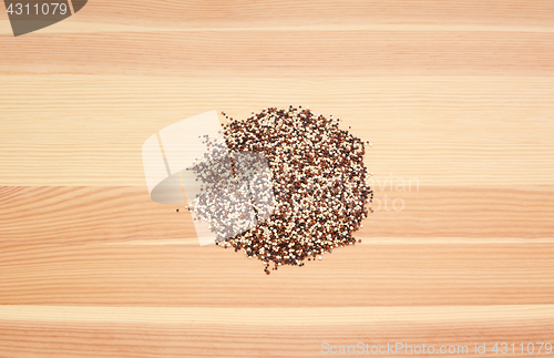 Image of Mixed red, white and black quinoa on wood