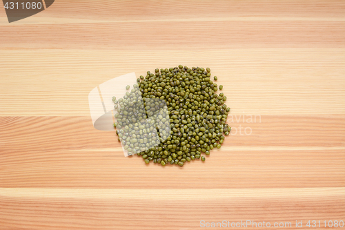 Image of Dried green mung beans on wood