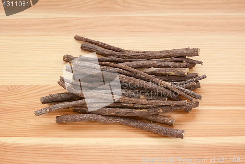 Image of Pile of liquorice root on wood
