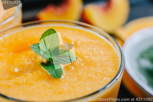 Image of Orange smoothie with leaves of fresh mint