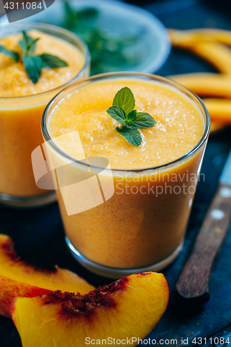 Image of Orange smoothie with leaves of fresh mint