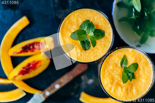 Image of Orange smoothie with leaves of fresh mint