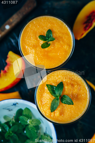 Image of Orange smoothie with leaves of fresh mint