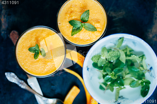 Image of Orange smoothie with leaves of fresh mint