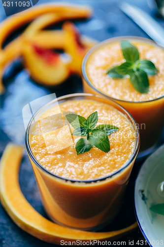 Image of Orange smoothie with leaves of fresh mint