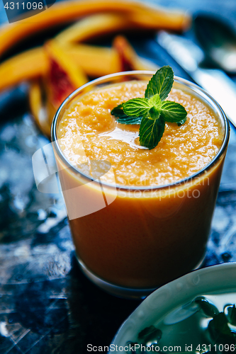 Image of Orange smoothie with leaves of fresh mint