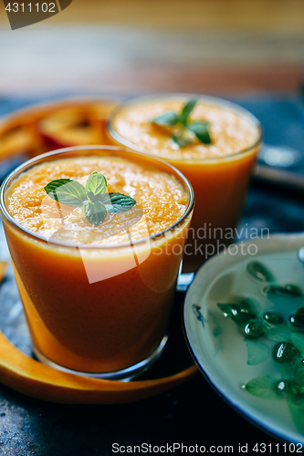 Image of Orange smoothie with leaves of fresh mint