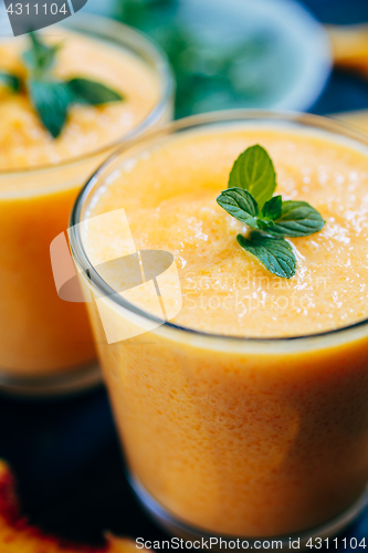 Image of Orange smoothie with leaves of fresh mint