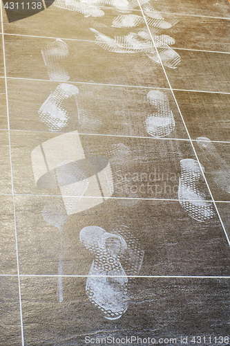 Image of Foot prints on the tiled floor