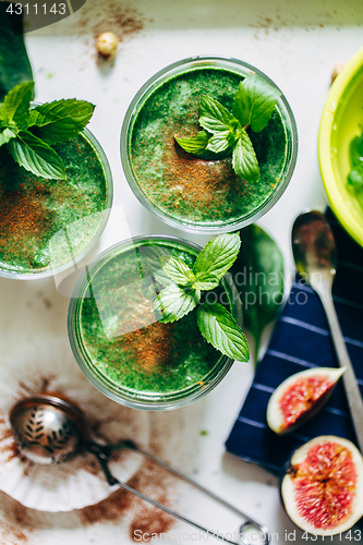 Image of Green smoothies with leaves of fresh mint