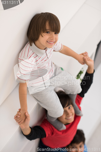 Image of young boys posing line up piggyback top view