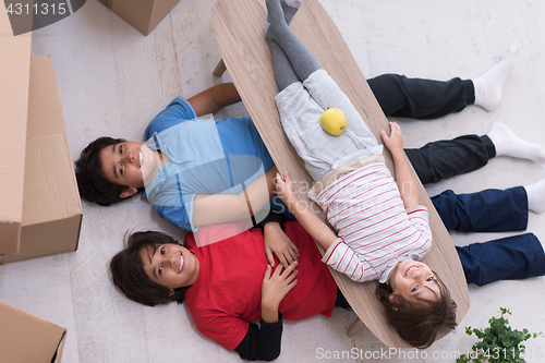 Image of boys with cardboard boxes around them top view