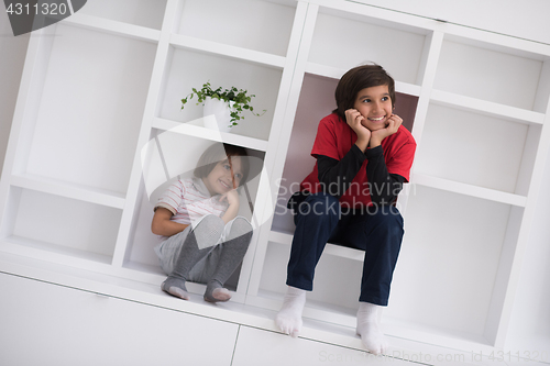 Image of young boys posing on a shelf