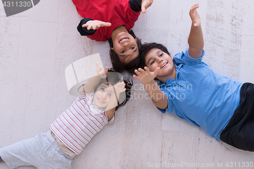 Image of young boys having fun on the floor