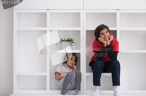 Image of young boys posing on a shelf