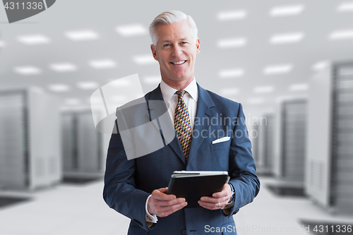 Image of Senior businessman in server room