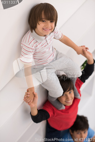Image of young boys posing line up piggyback top view