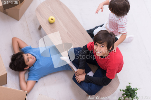 Image of boys with cardboard boxes around them top view