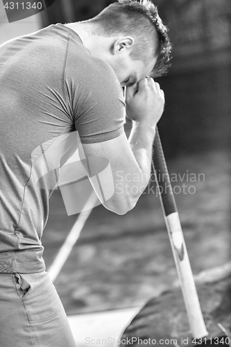 Image of man workout with hammer and tractor tire