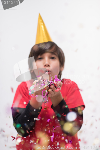 Image of kid blowing confetti