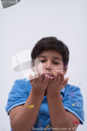 Image of kid blowing confetti