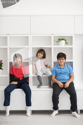 Image of young boys posing on a shelf