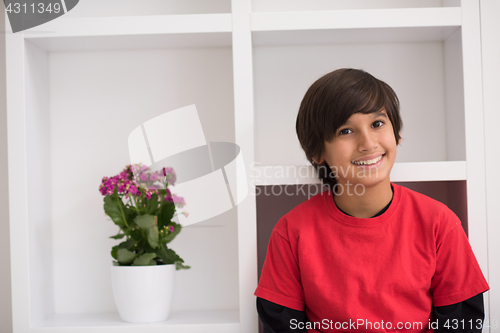 Image of young boy posing on a shelf