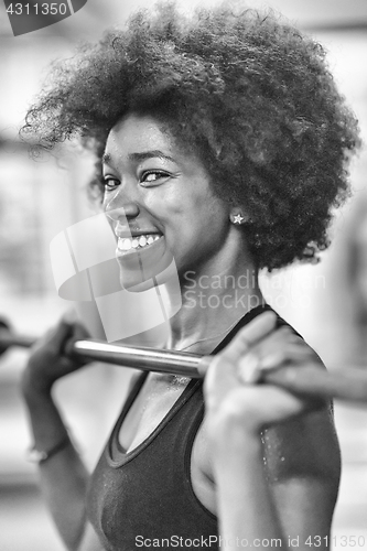 Image of black woman lifting empty bar