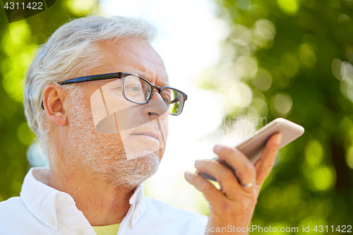 Image of old man using voice command recorder on smartphone