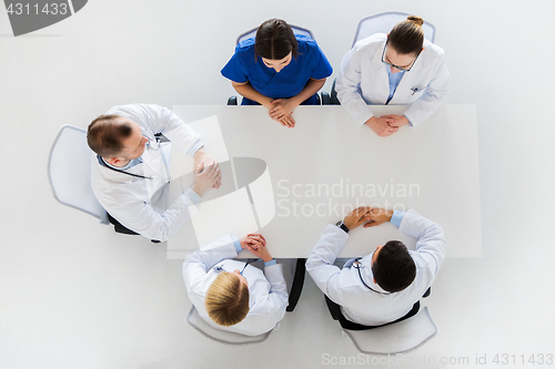 Image of group of doctors sitting at empty table