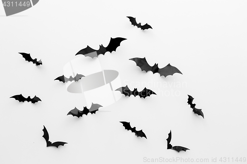 Image of black paper bats over white background