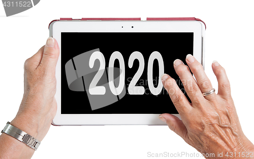 Image of Senior lady relaxing and her tablet - 2020