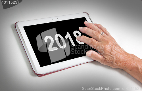 Image of Senior lady relaxing and her tablet - 2018