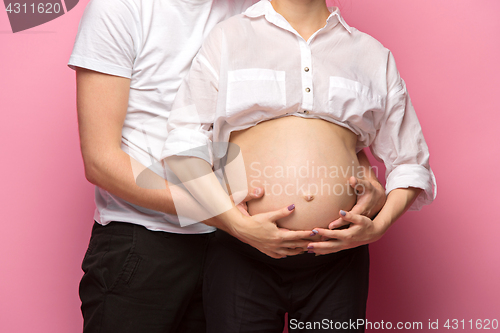 Image of The handsome man and his beautiful pregnant wife\'s tummy