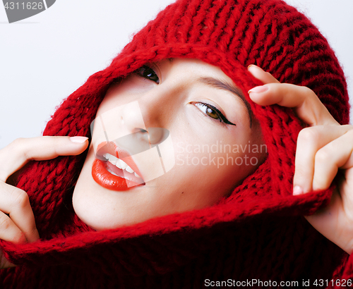 Image of young pretty woman in sweater and scarf all over her face