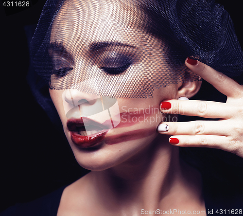 Image of beauty brunette woman under black veil with red manicure close up