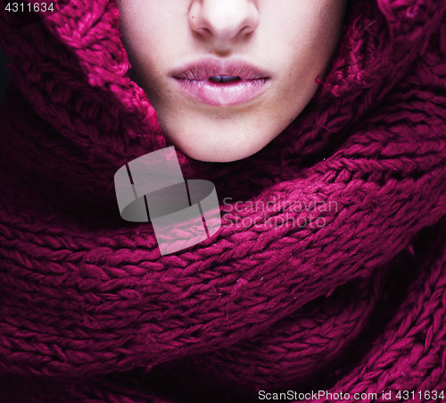 Image of young pretty woman lips in sweater and scarf all over her face